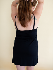 Woman wearing women's sleepwear bamboo lounge dress in black, back