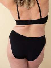 Woman wearing comfortable underwear bikini style in black, back