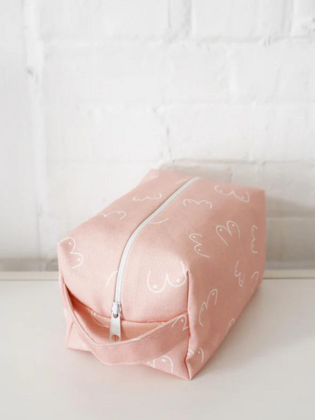 Make up bag in pink on a counter top