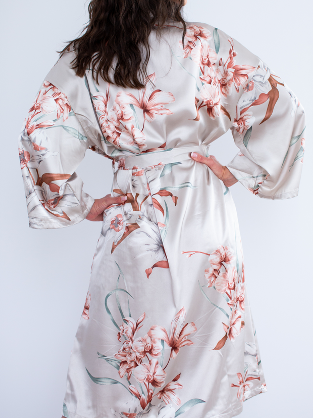 Woman wearing satin robe in floral, back
