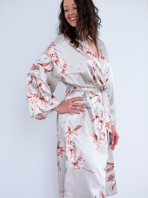 Woman wearing satin robe in floral, hand on hip