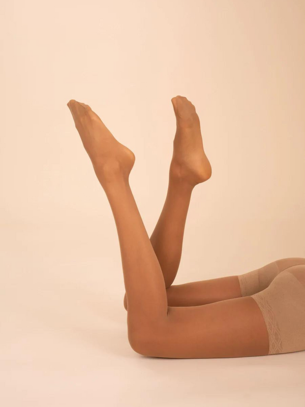 Woman wearing sheer tights in tan, side