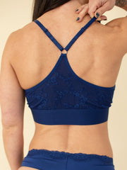 Woman wearing blue wireless bra, back view, close